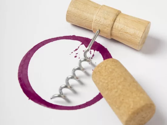 gros plan sur les details de la tache de vin avec un tire bouchon et un bouchon